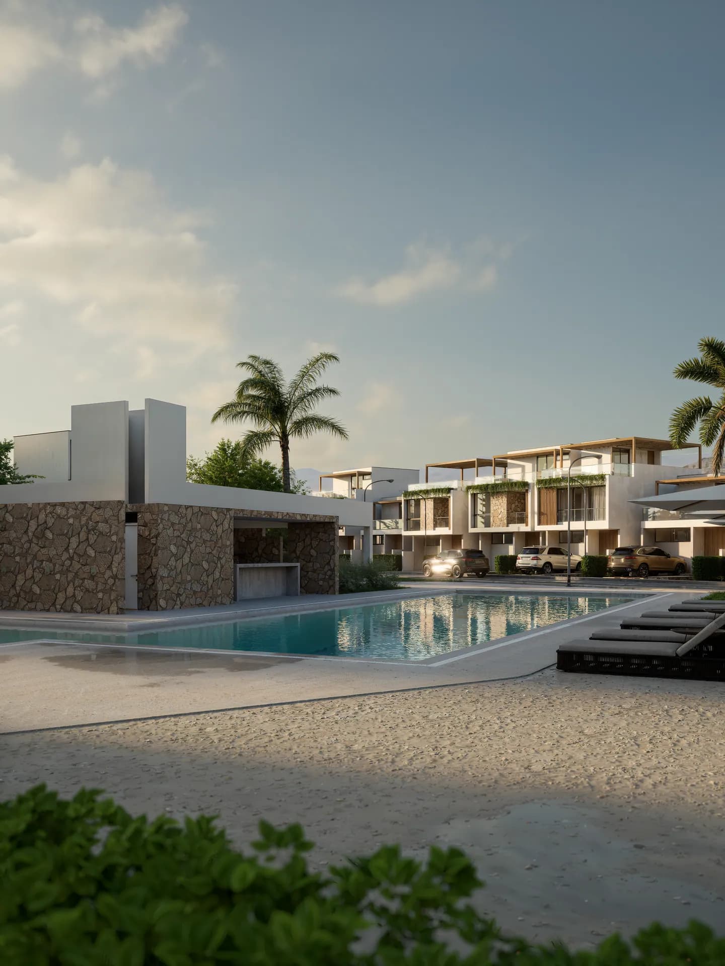 Club house y piscina de Residencial Aonami vistos desde el borde del agua
