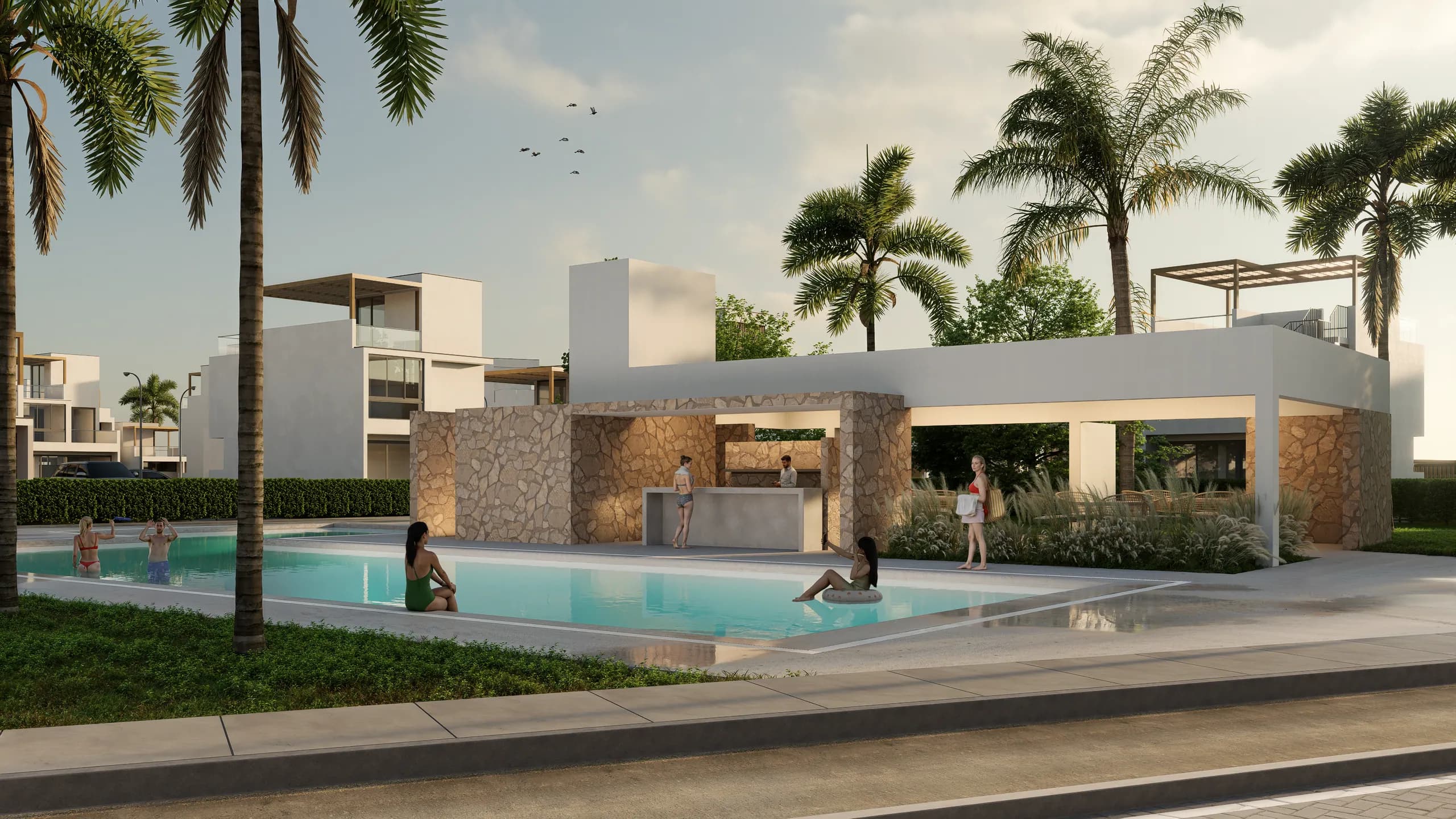 Piscina de Residencial Aonami con el club house de muro de piedra y palmeras al fondo