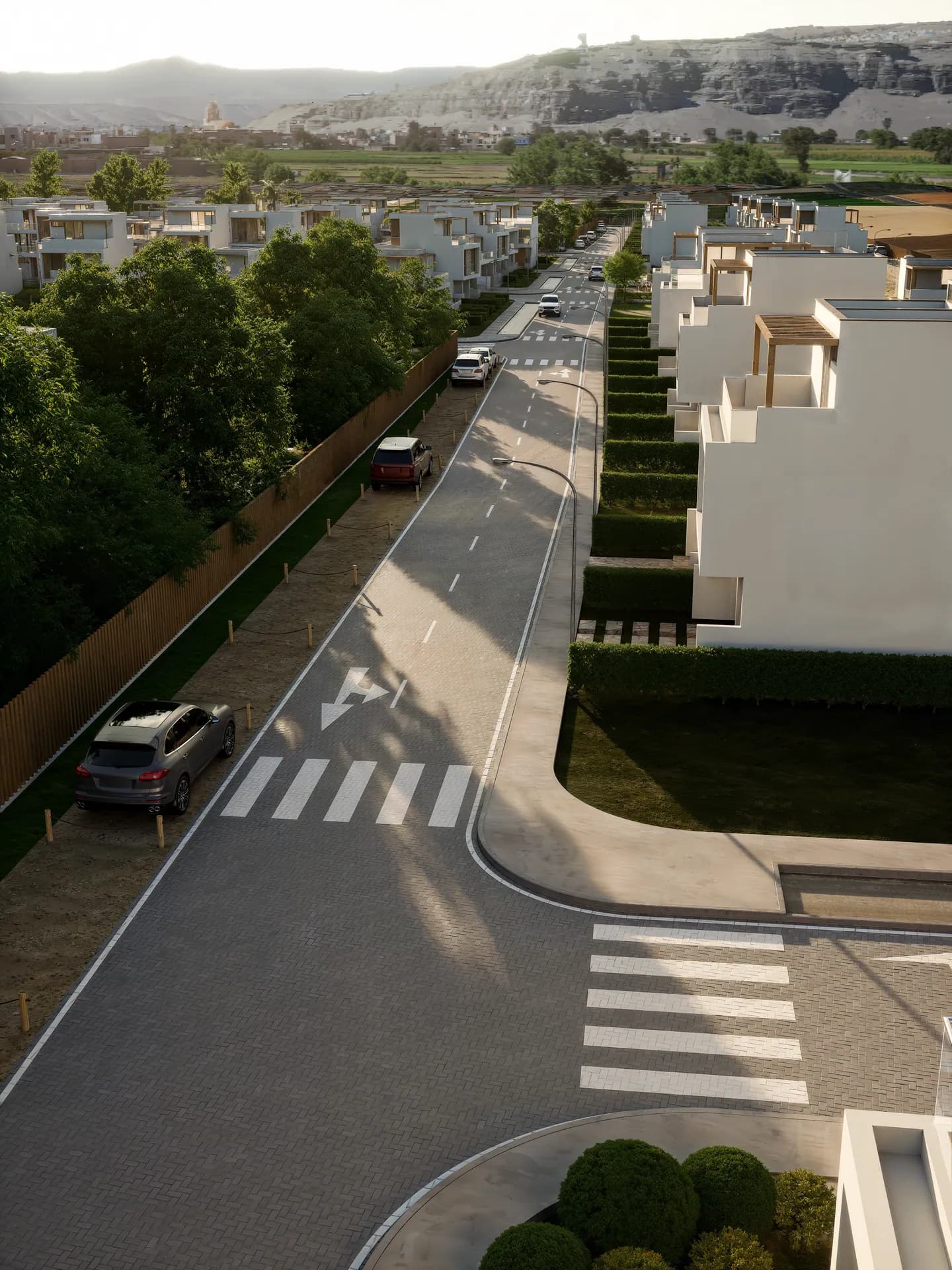 Vía interna adoquinada en perspectiva, con casas y cruce peatonal